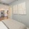 a bedroom with a bed and a shelf